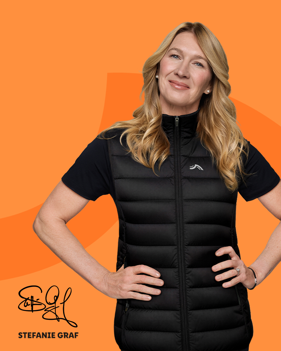 Woman in black puffer vest with hands on hips, smiling; below, Stefanie Graf signature.
