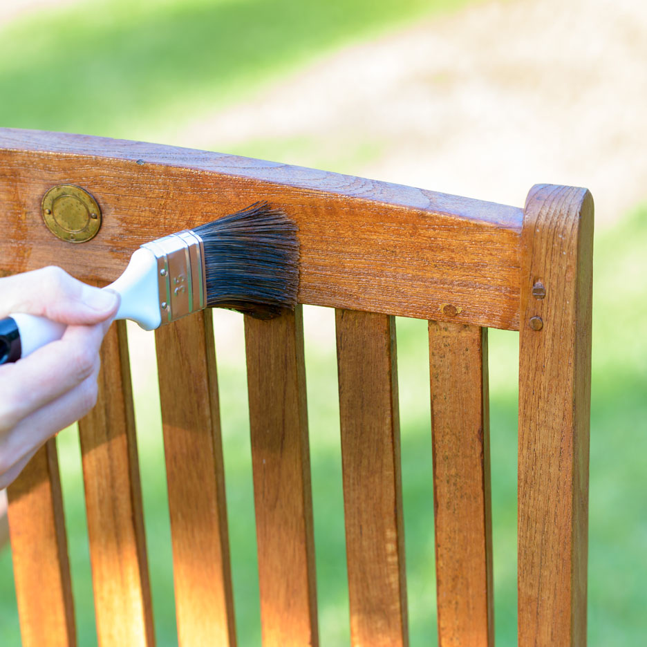 Oiling a wooden chair.