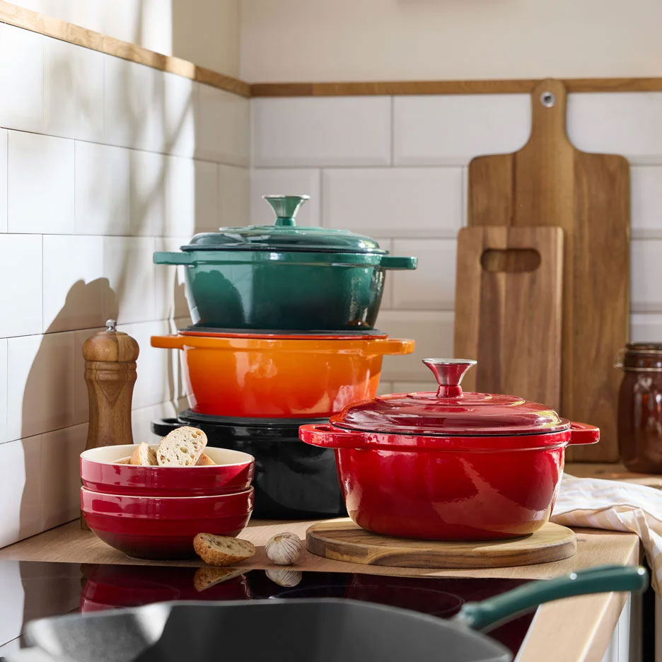 Colorful cast iron pots and bowls on a kitchen counter.