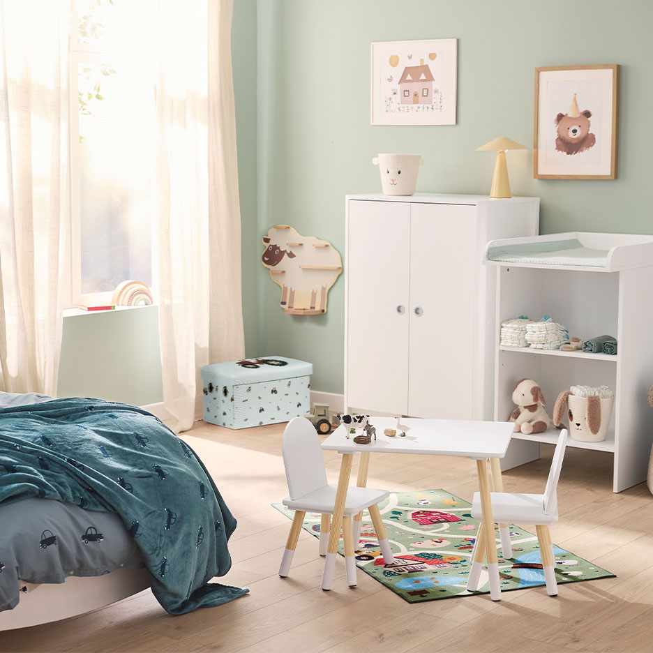 Children's room with a white wardrobe, changing table, and a small table with chairs.